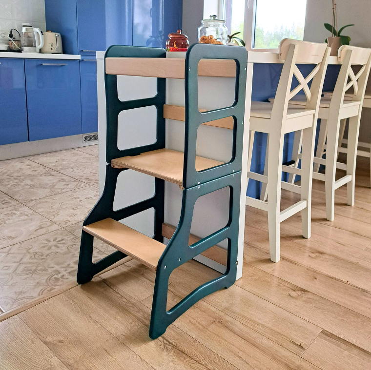 Children's step stool with green frame and wooden steps in a kitchen setting