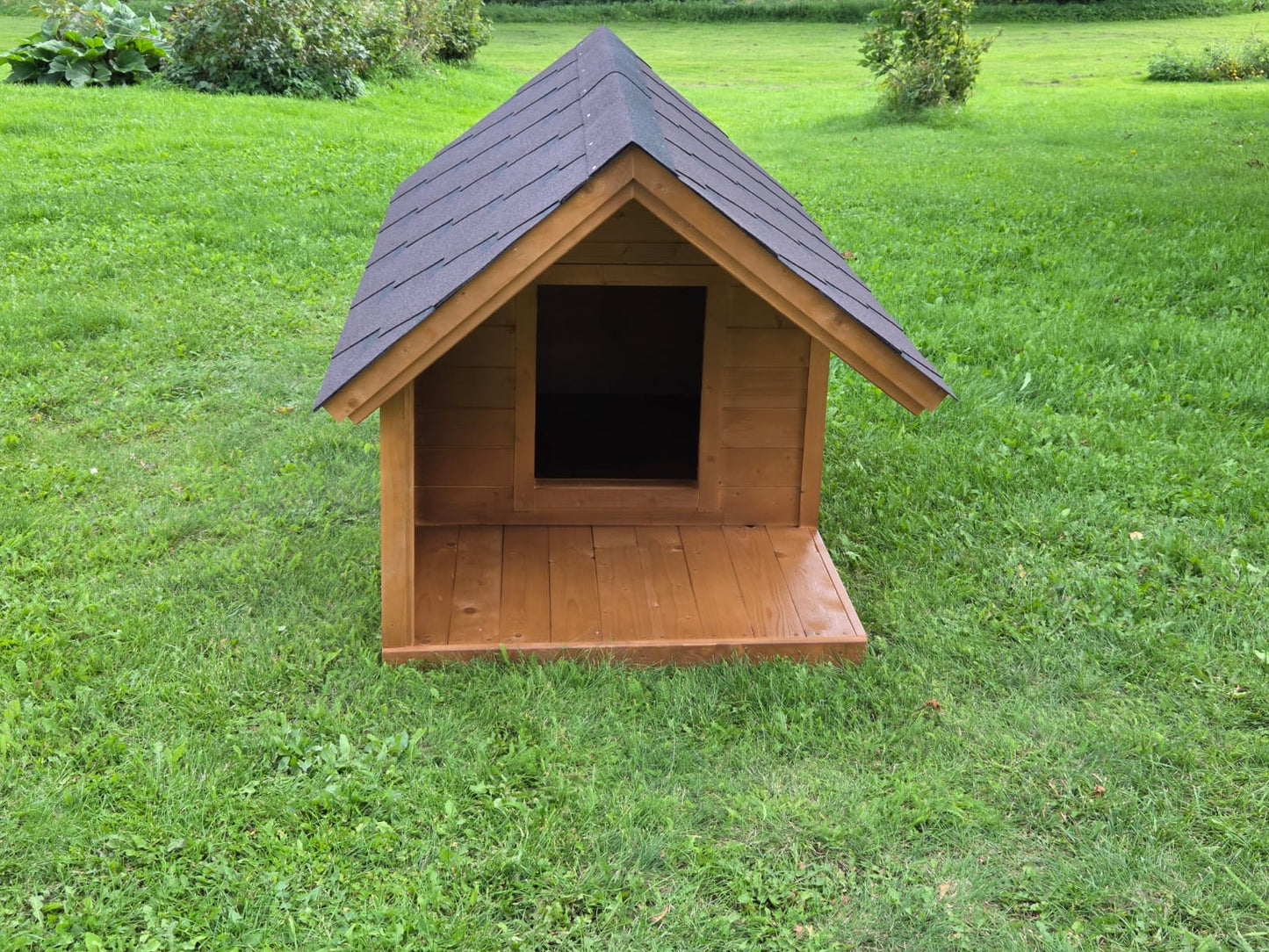 Wooden doghouse on a grassy field