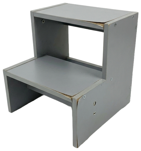 A cheap gray particleboard step stool