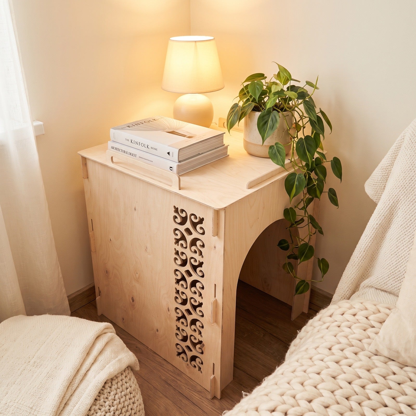 The birch cover used as a real side table: a lamp, books and a plant on top - it doubles as a shelf.